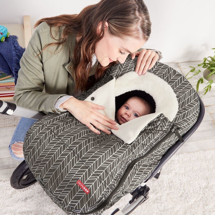 Baby in car seat with cover