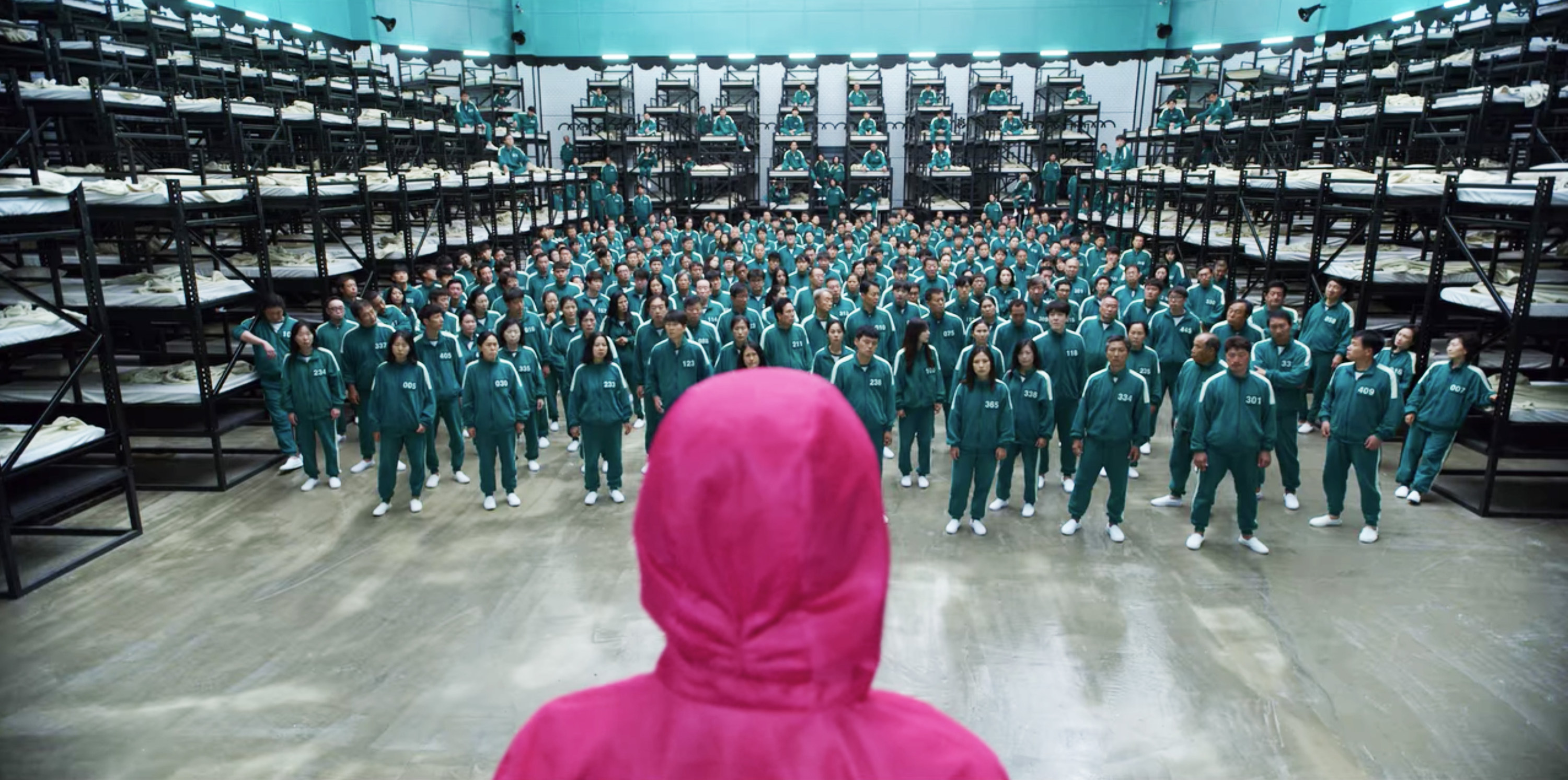 A Squid Game guard looks at the 456 contestants in the dorm room