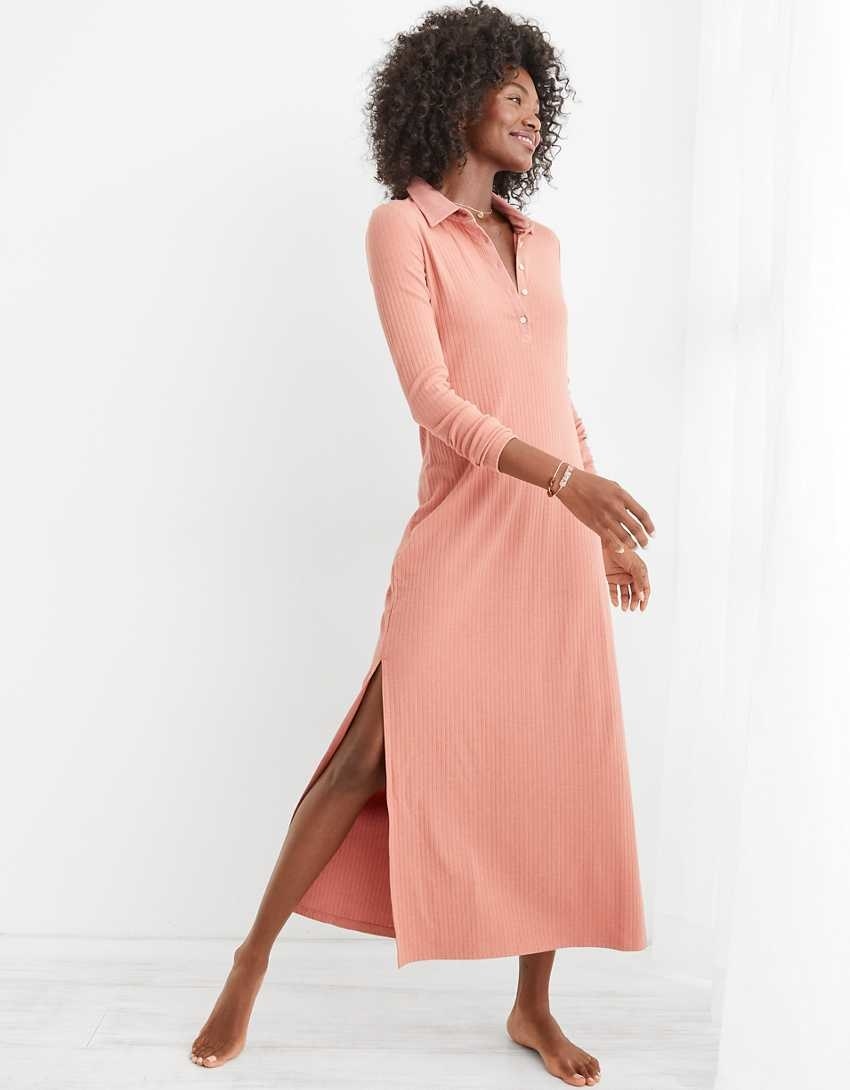 model wearing the dress in pink with a slit just above the knee