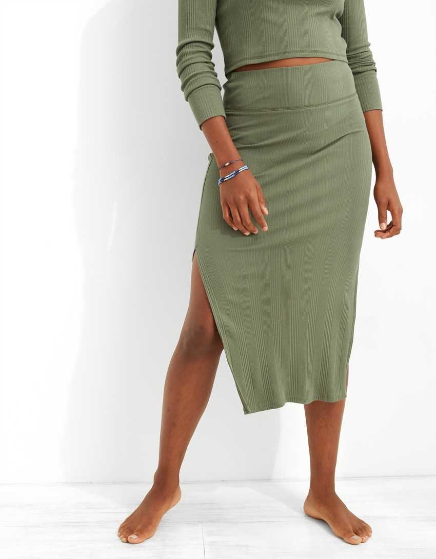 model wearing the skirt from the waist down in green with a matching shirt