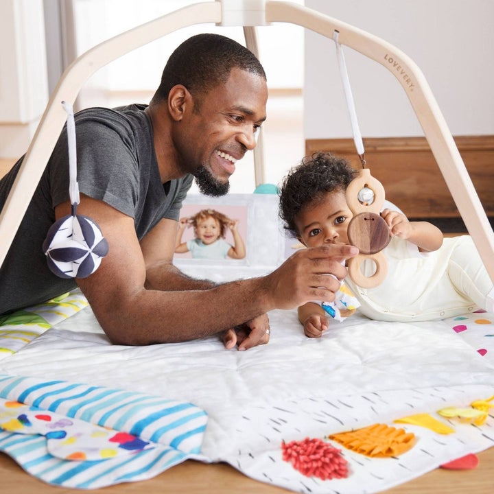 Baby and parent playing in the play gym