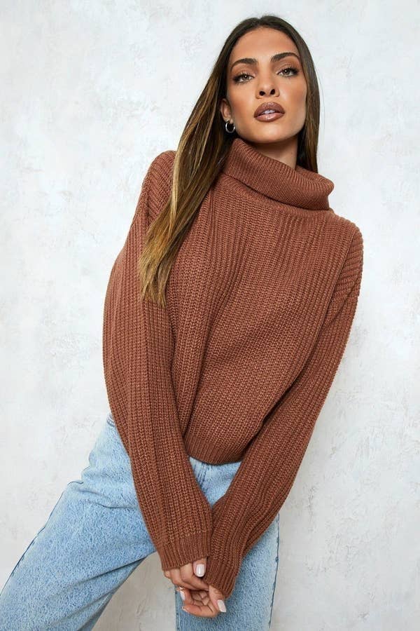 a model wearing the cropped sweater with a high neck
