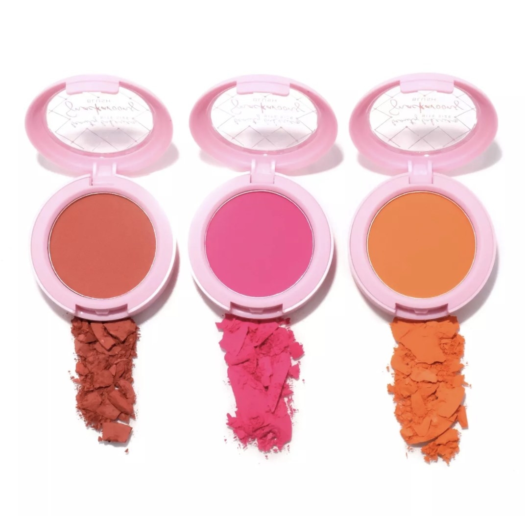There is a mauve, coral and orange blush all in light pink packaging and with a powder trail