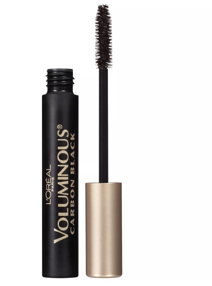 The black mascara tube says &quot;L&#x27;OREAL VOLUMINOUS CARBON BLACK&quot; in gold lettering and has a gold lid