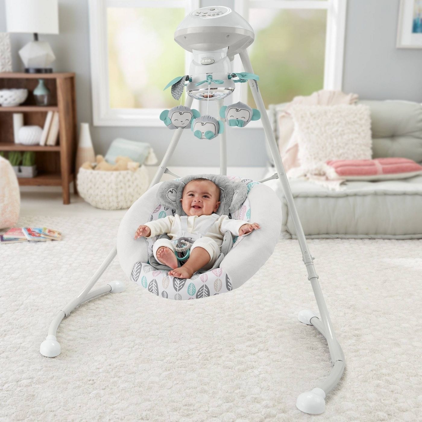 Fisherprice baby swing with baby in it