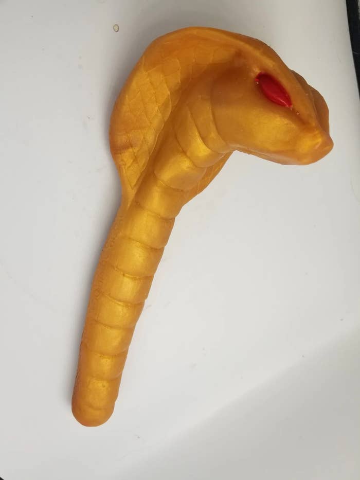 Gold snake-shaped scepter dildo with red eyes