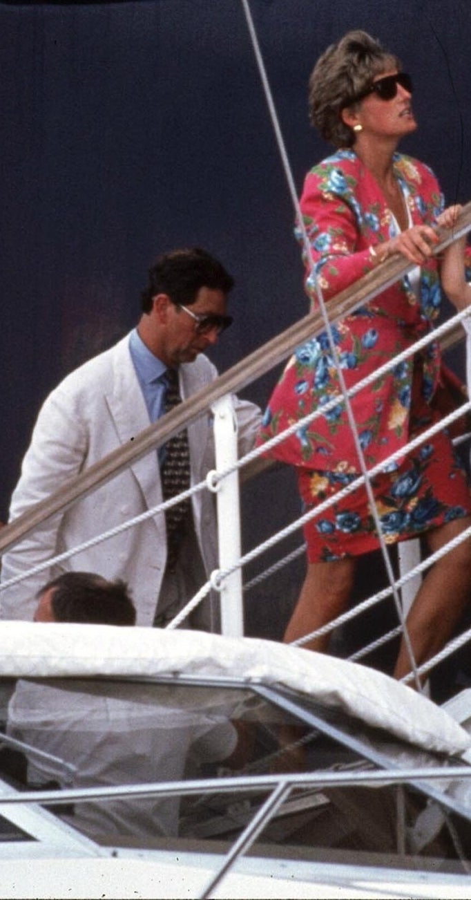 The couple walking up a short flight of stairs onto the yacht