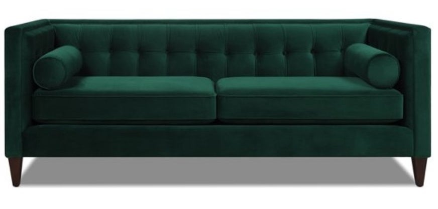A evergreen, tufted velvet sofa