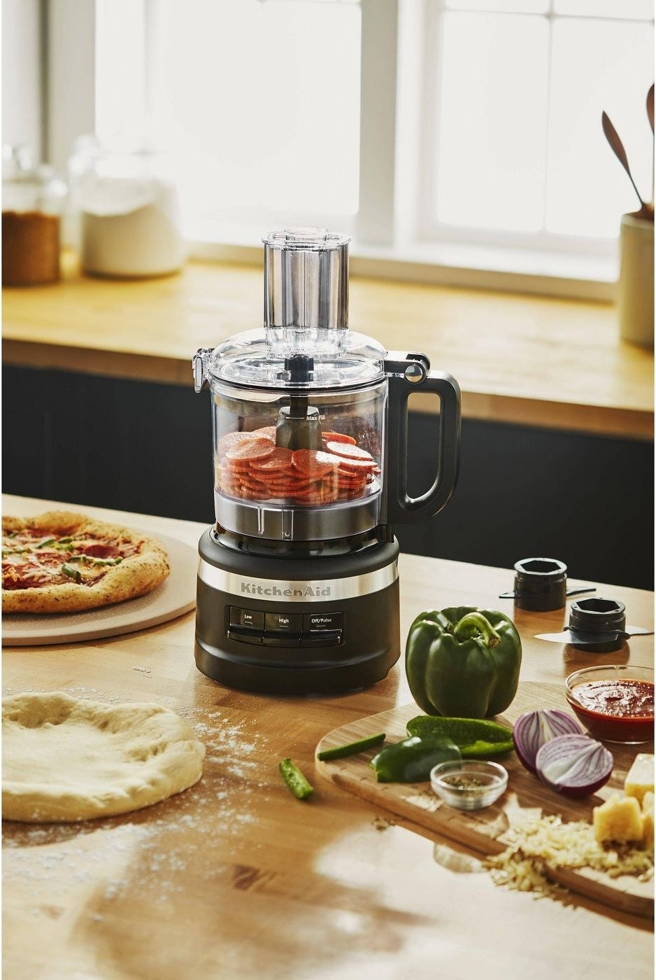 the food processor surrounded by pizza ingredients