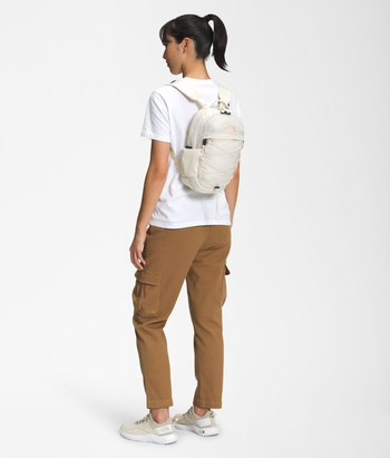 model wearing white mini backpack