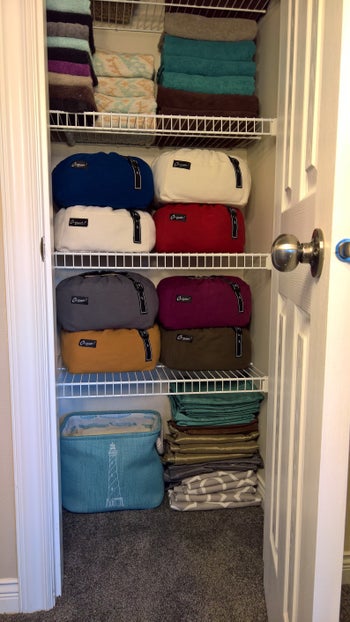 after photo showing how nice and organized the linen closet is using the fabric storage containers