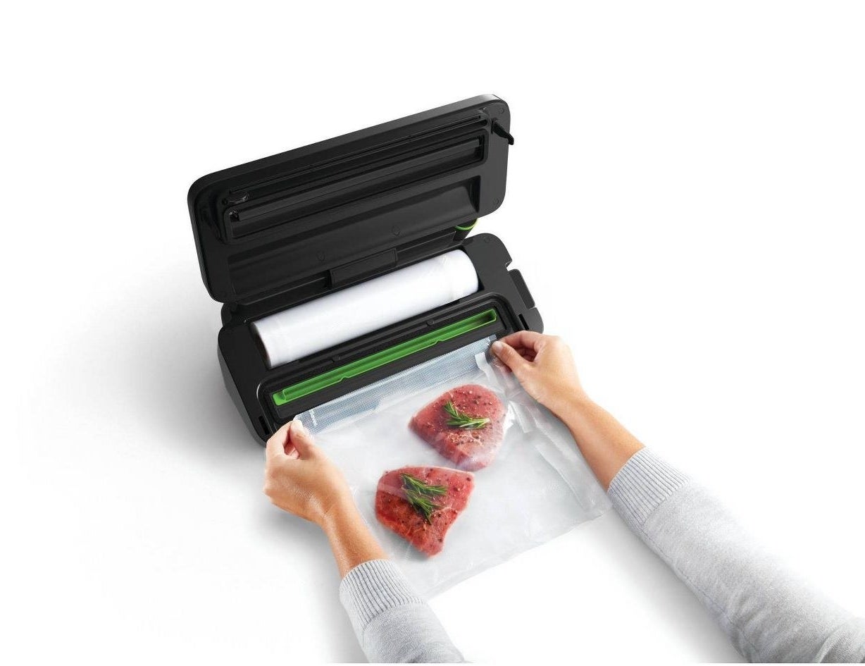 a model sealing steaks with the food sealer