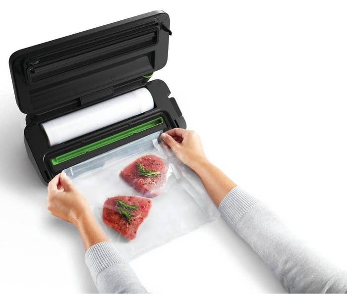 a model sealing steaks with the food sealer