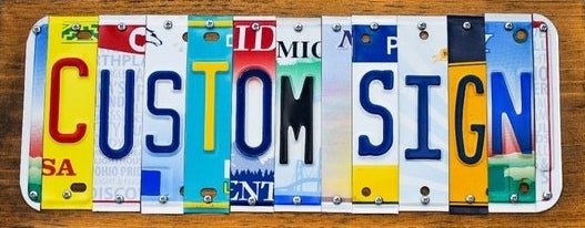 Product image of multicolored license plate that says "custom sign"