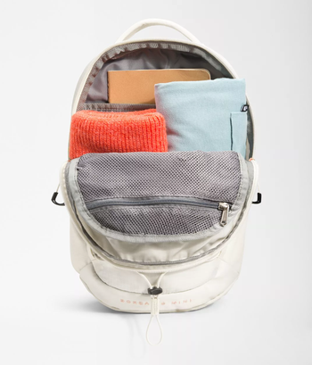 product image of the backpack zipped open with stuff inside