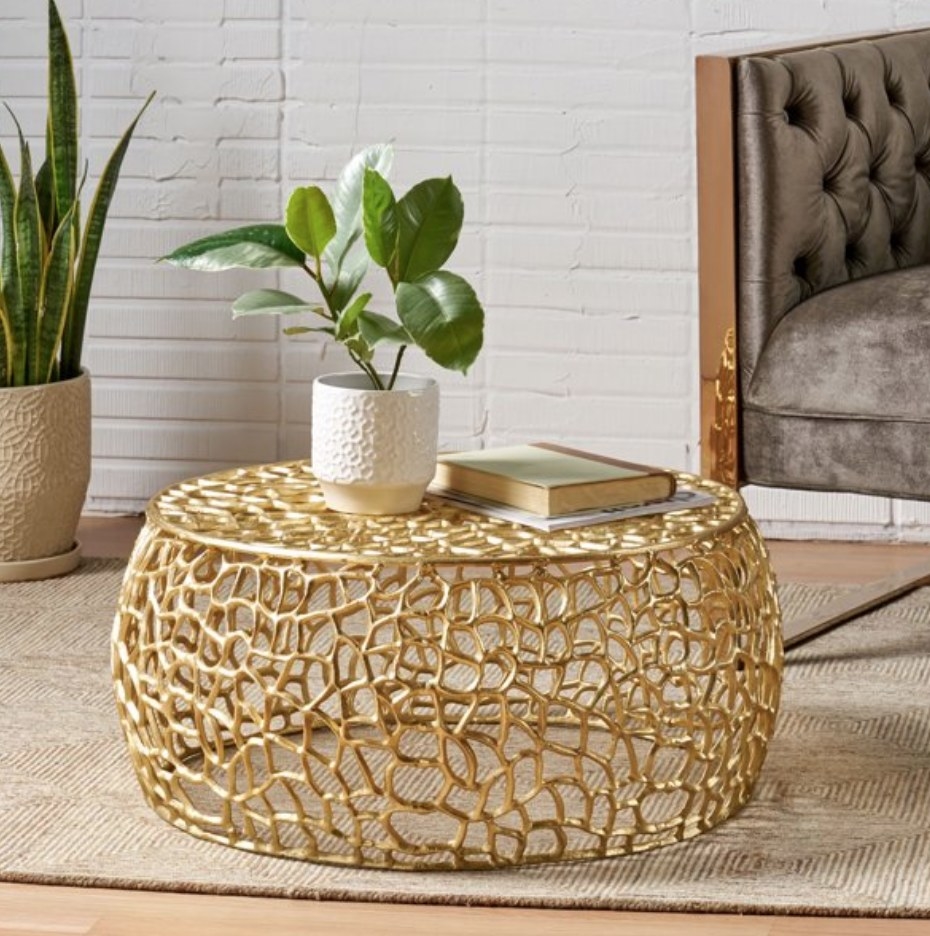 A gold, modern round coffee table