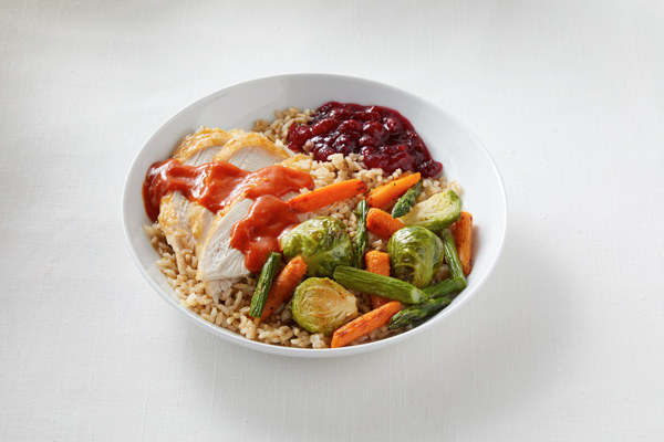 bowl with rice and turkey and cranberry sauce and fall veggies