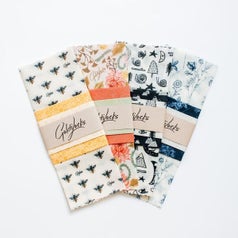 A pack of four beeswax food wraps in different designs and colors