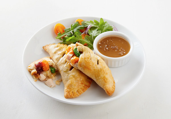 turkey hand pies served with a side salad and gravy