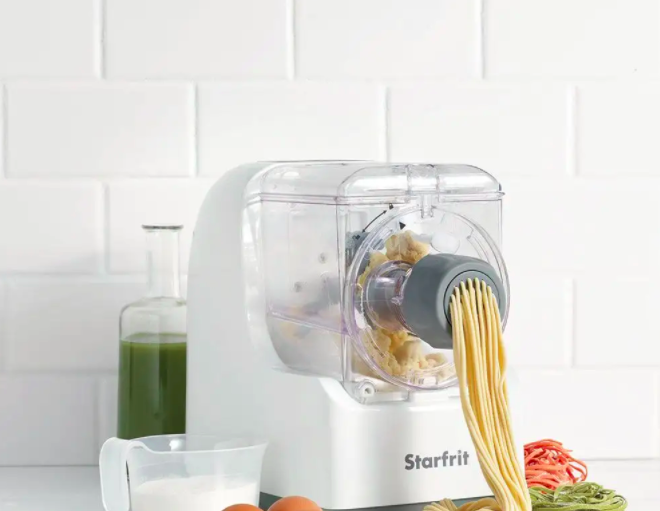 a pasta maker squeezing out fresh spaghetti