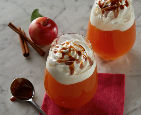 hot bourbon cider topped with whipped cream and caramel sauce