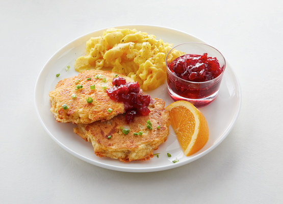 turkey and cheese pancakes served with scrambled eggs and side of cranberry sauce