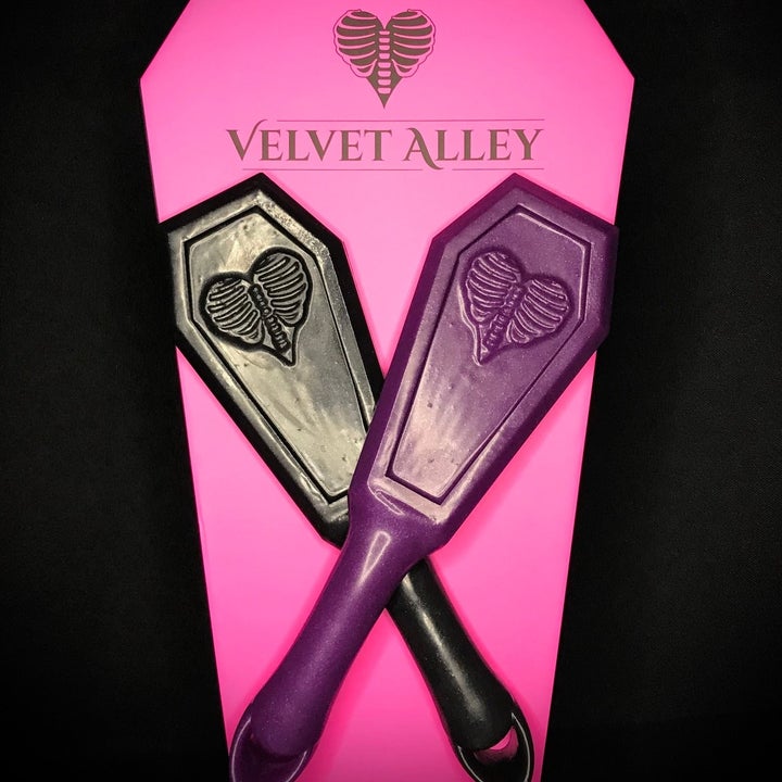 Purple and black coffin-shaped paddles
