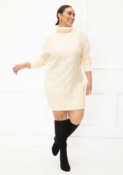 A cream cable knit sweater dress