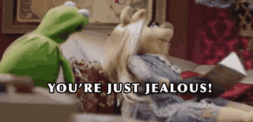 a gif of kermit and miss piggy saying &quot;you&#x27;re just jealous!&quot;