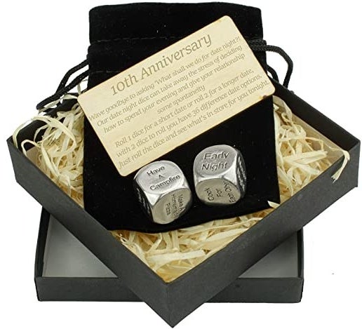 Product image of square gift box with black velvet drawstring bag, wooden card titled &quot;10th anniversary&quot; and two silver dice that say &quot;have a campfire&quot; and &quot;early night&quot;