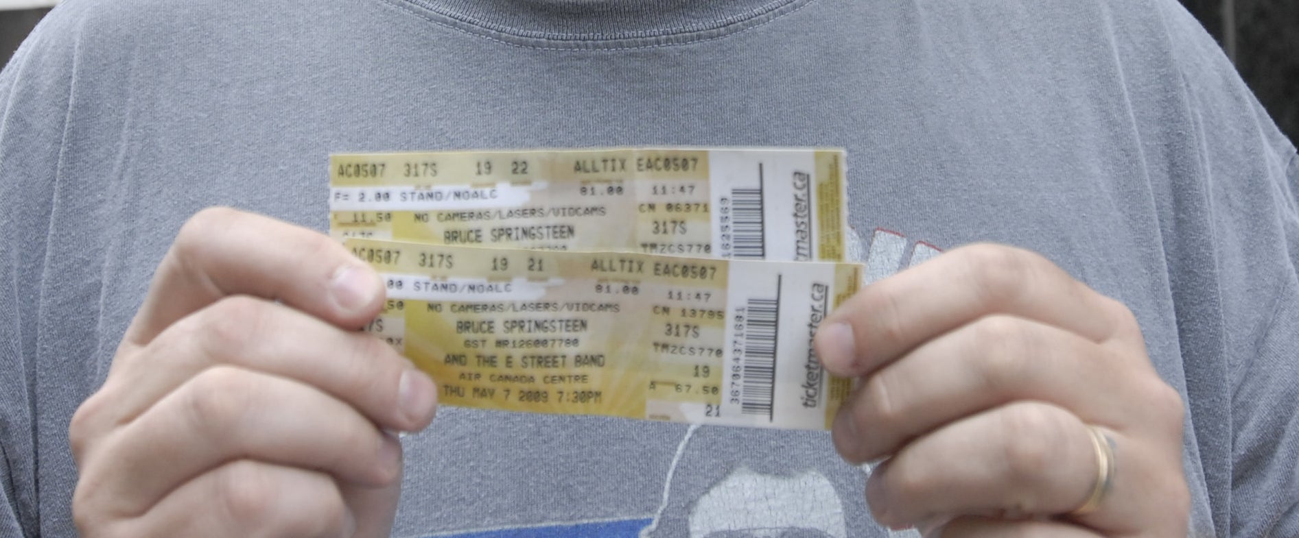 Man holding two yellow tickets