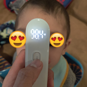 Reviewer taking temperature of their child