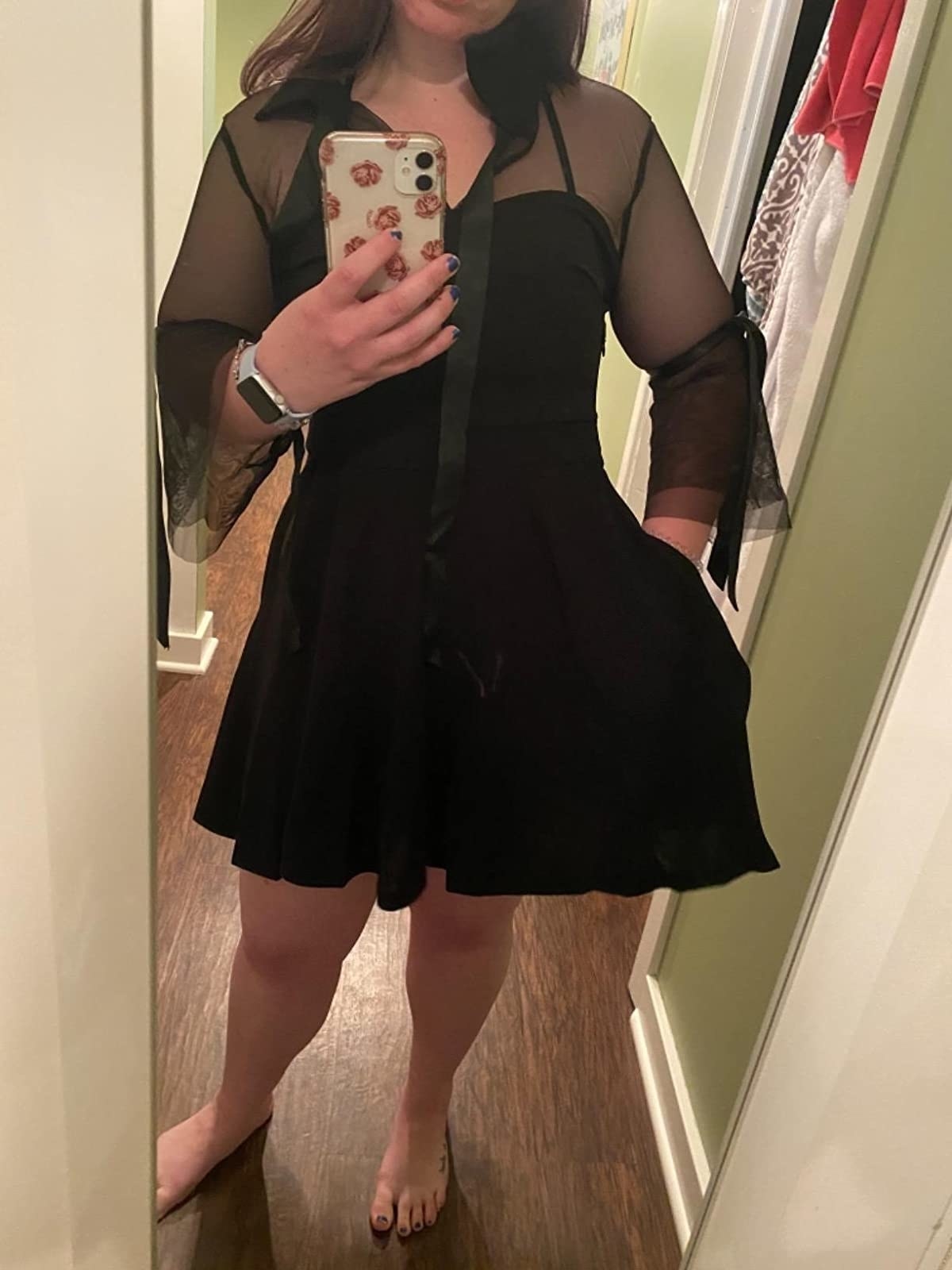 Reviewer wearing dress with sheer sleeves