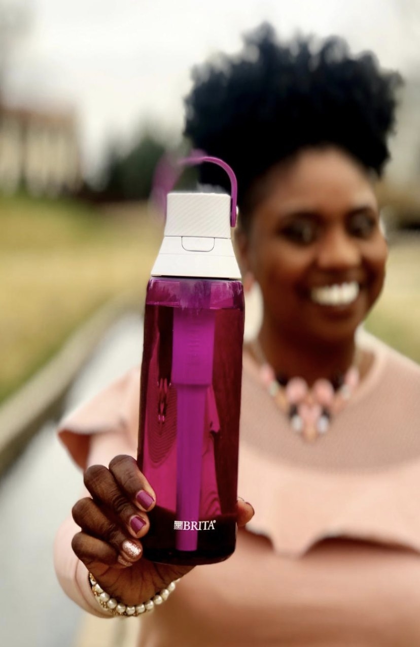 a person holding the bottle in orchid