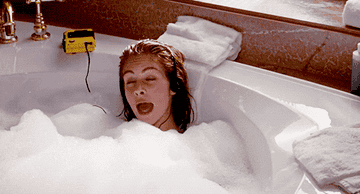gif of julia roberts listening to a walkman in the bathtub in &quot;pretty woman&quot;