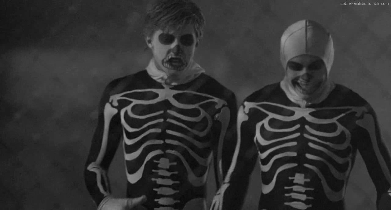 Cobra Kai members in black and white skeleton Halloween costumes
