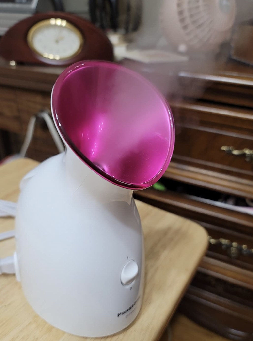 a pink and white facial steamer