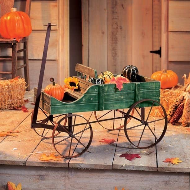The green decorative wagon on a porch.