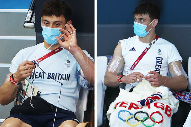 Tom Daley knitting a cardigan while sitting in the stands for an Olympic diving event