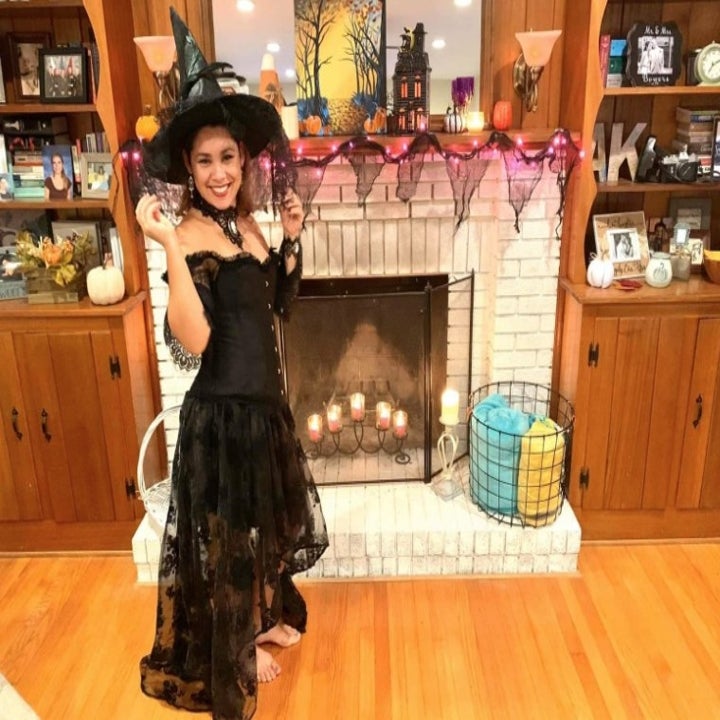 a reviewer wearing the dress with a witch hat