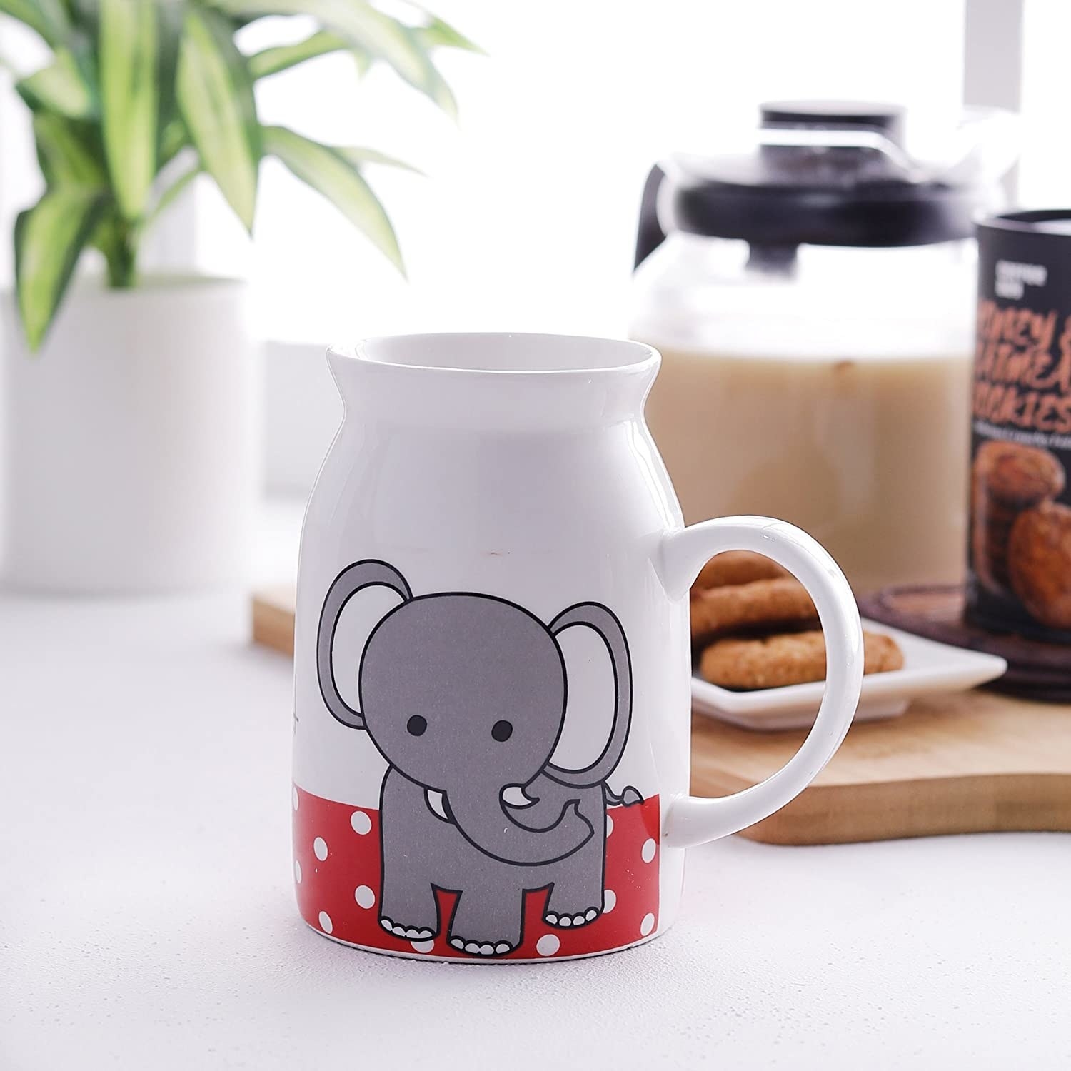 A mug with an elephant and some polka dots on it