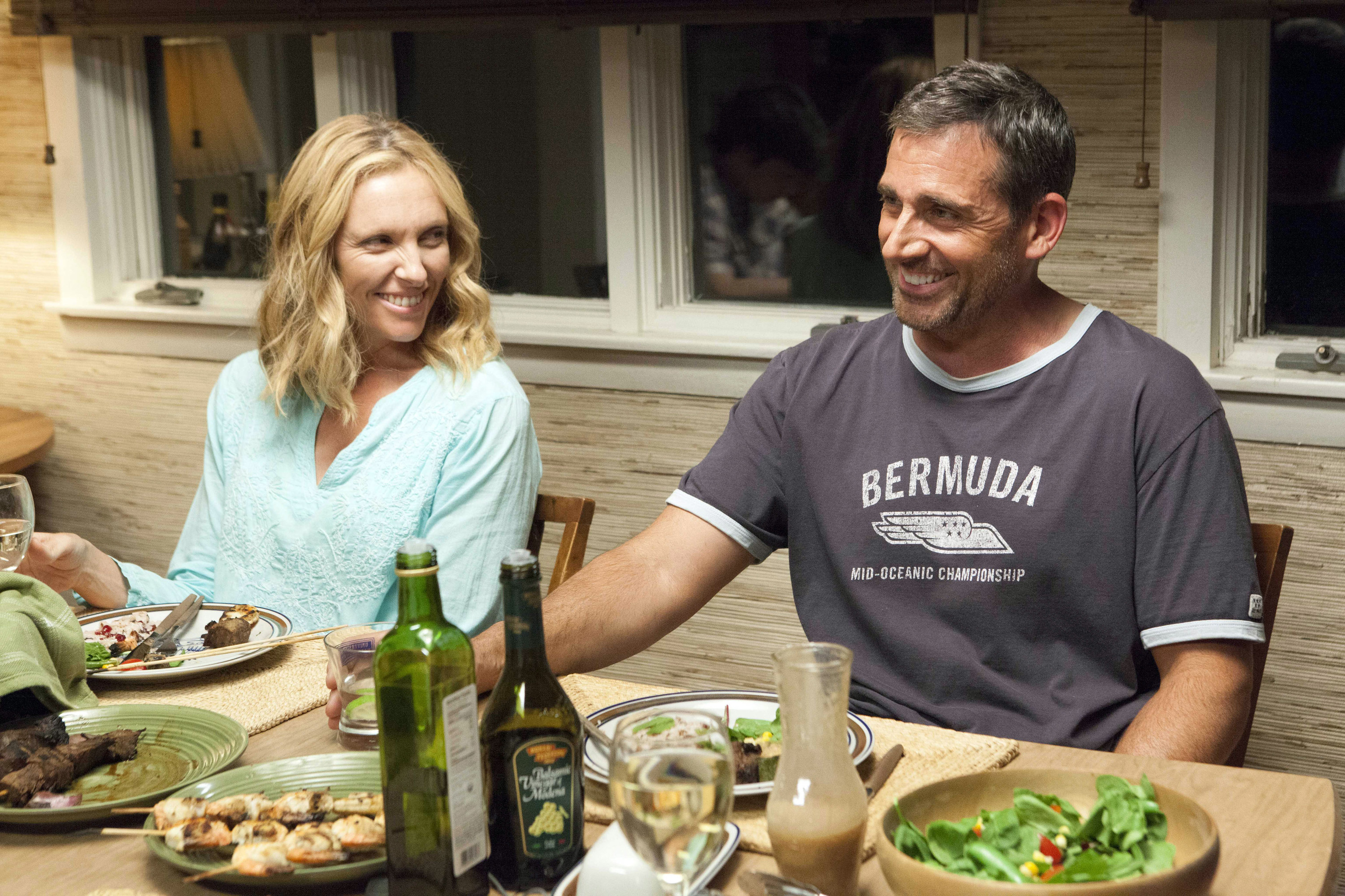 Toni Collette and Steve Carell smile at a dinner table