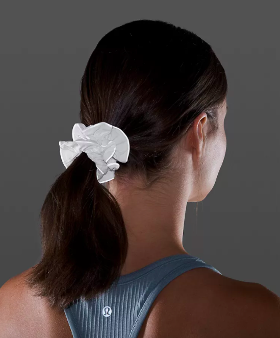 a reflective scrunchie holding up a person&#x27;s ponytail