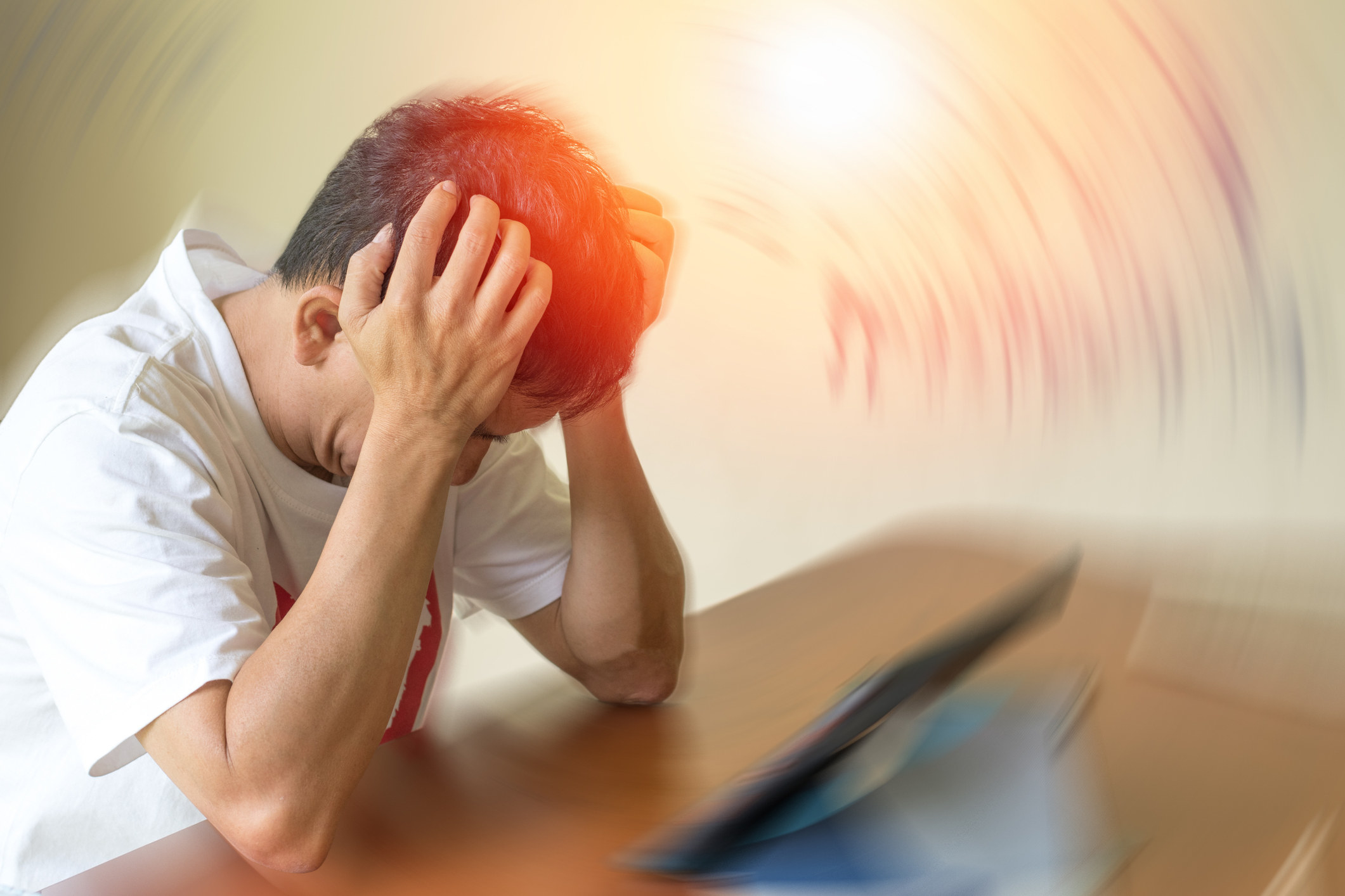 Person appearing to be in pain  clutching their head
