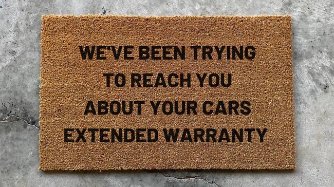 The doormat that reads We've Been Trying to Reach You About Your Cars Extended Warranty