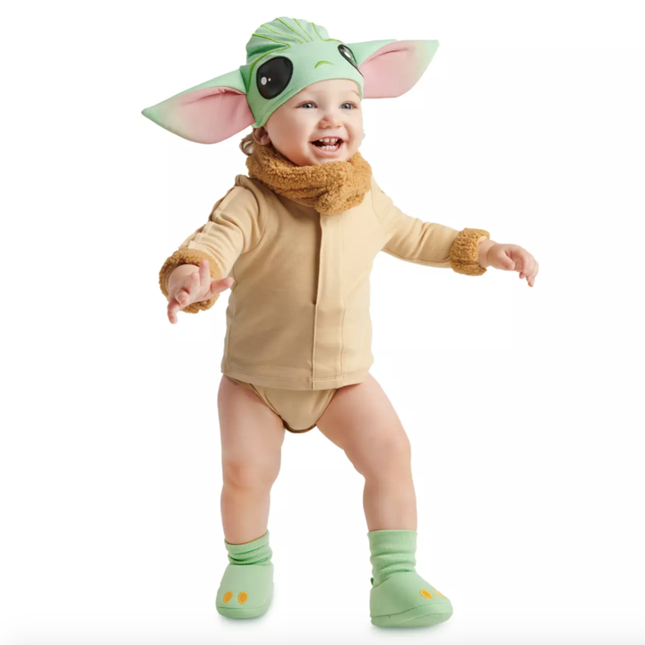 a baby in the baby yoda costume