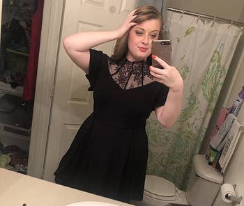 Reviewer wearing black dress with lace mesh neckline