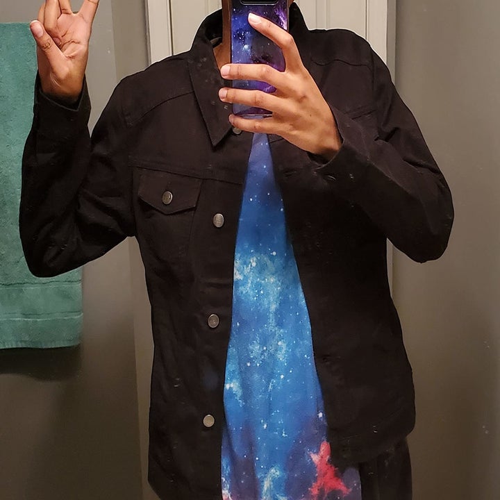 Reviewer wearing black denim jacket