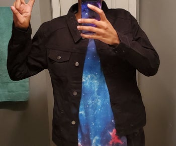 Reviewer wearing black denim jacket