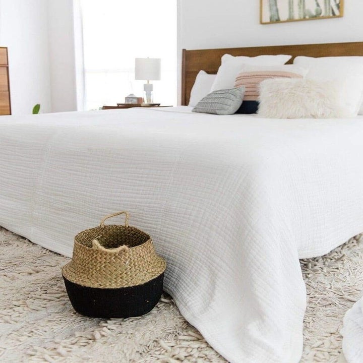 A white blanket covering an entire bed